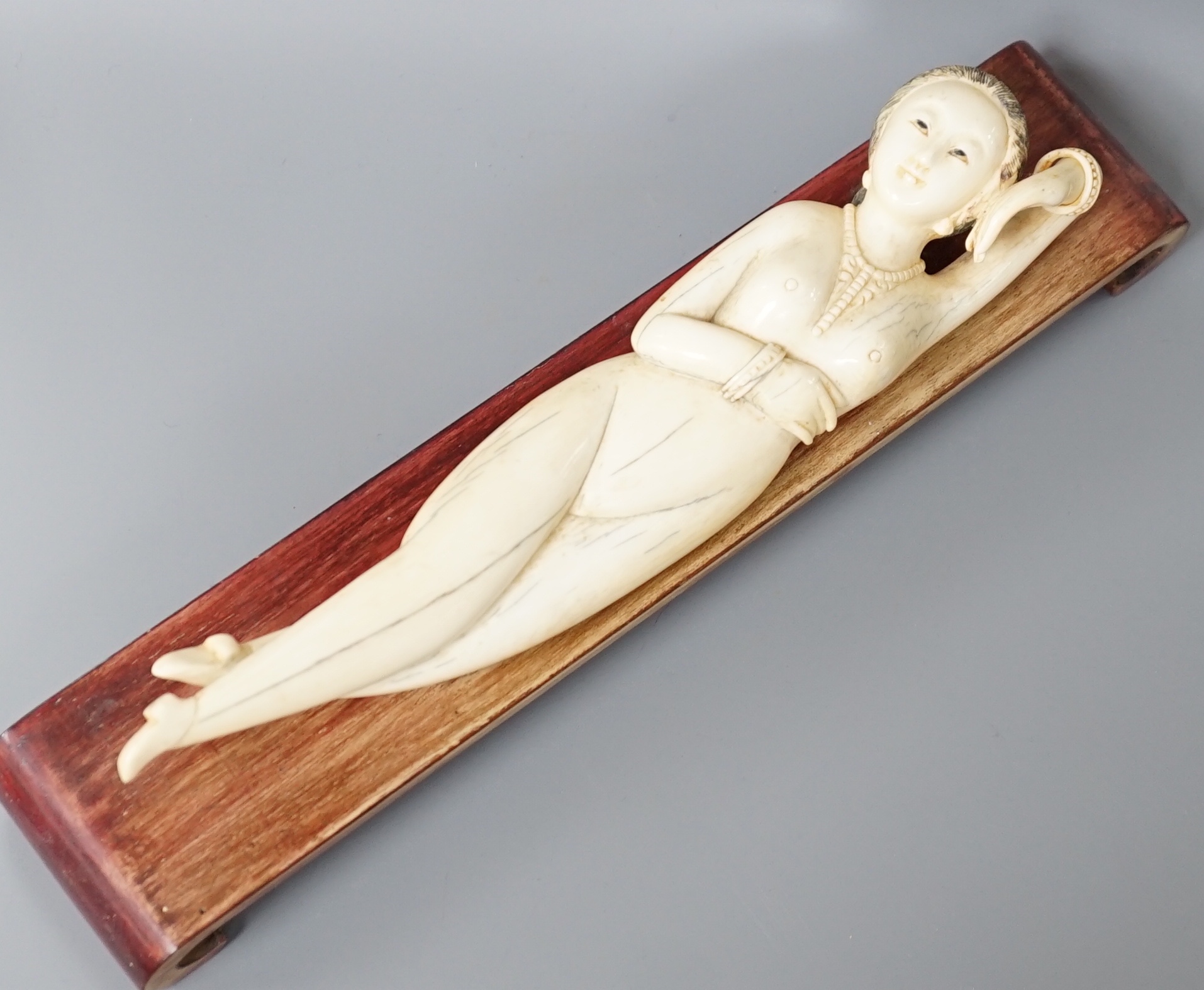 A Chinese carved ivory medicine figure, late 19th/early 20th century, wood stand. 25cm excl stand
